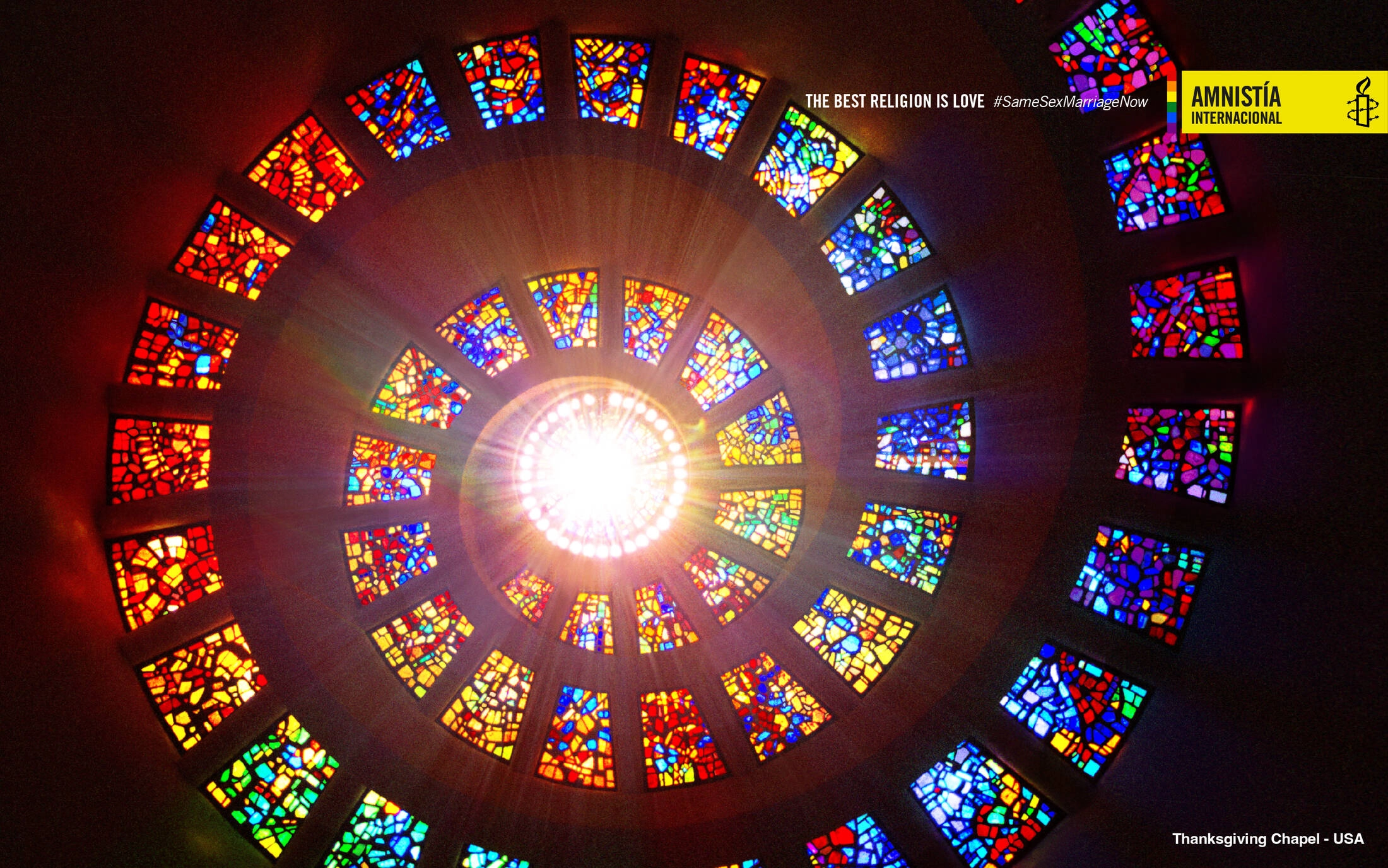 La mejor religión es el amor: vitral de catedral con luz multicolor que desciende en espiral